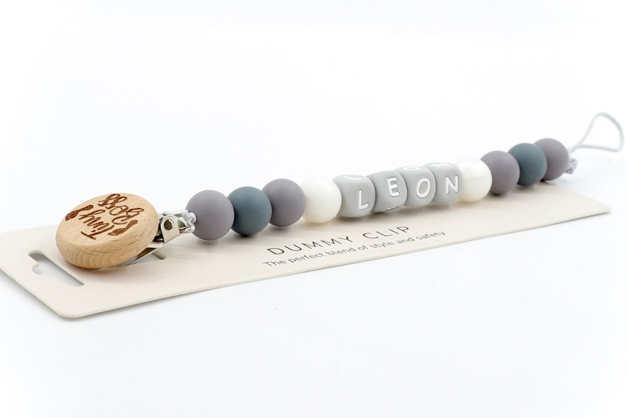 Little Nibbles pacifier clip in Cloud Grey and cloud white with custom name LEON and smooth silicone beads