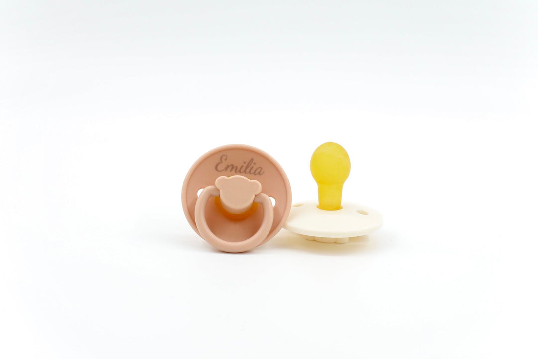 Sage green Bear Essentials pacifier featuring ergonomic handle and BPA-free silicone nipple, suitable for babies aged 0–6 months.