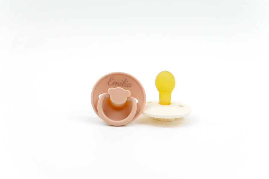 Sage green Bear Essentials pacifier featuring ergonomic handle and BPA-free silicone nipple, suitable for babies aged 0–6 months.