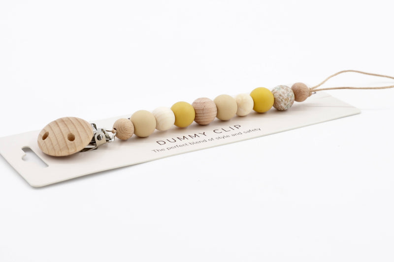 Velvet Sands Dummy Chain in warm mustard and natural tones, combining silicone and wood textures with a wooden safety clip, presented on display card.