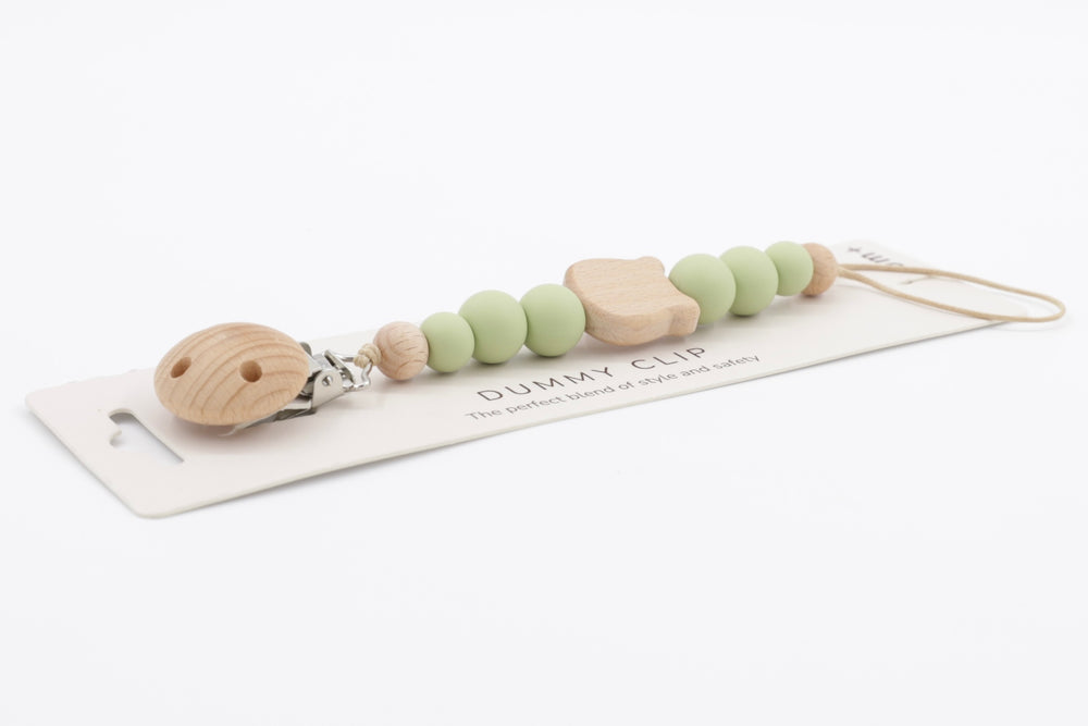 Silhouette Bear dummy clip in soft sage with round silicone beads and natural wood bear-shaped detail, shown on branded card