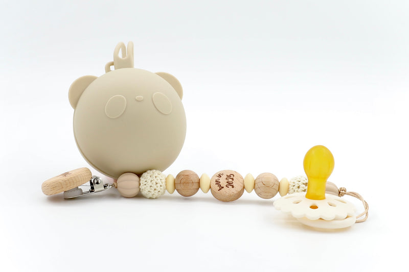 Cozy Knot Trio pacifier set in Oatmeal Cream with bear-shaped silicone case, hand-tied bead clip