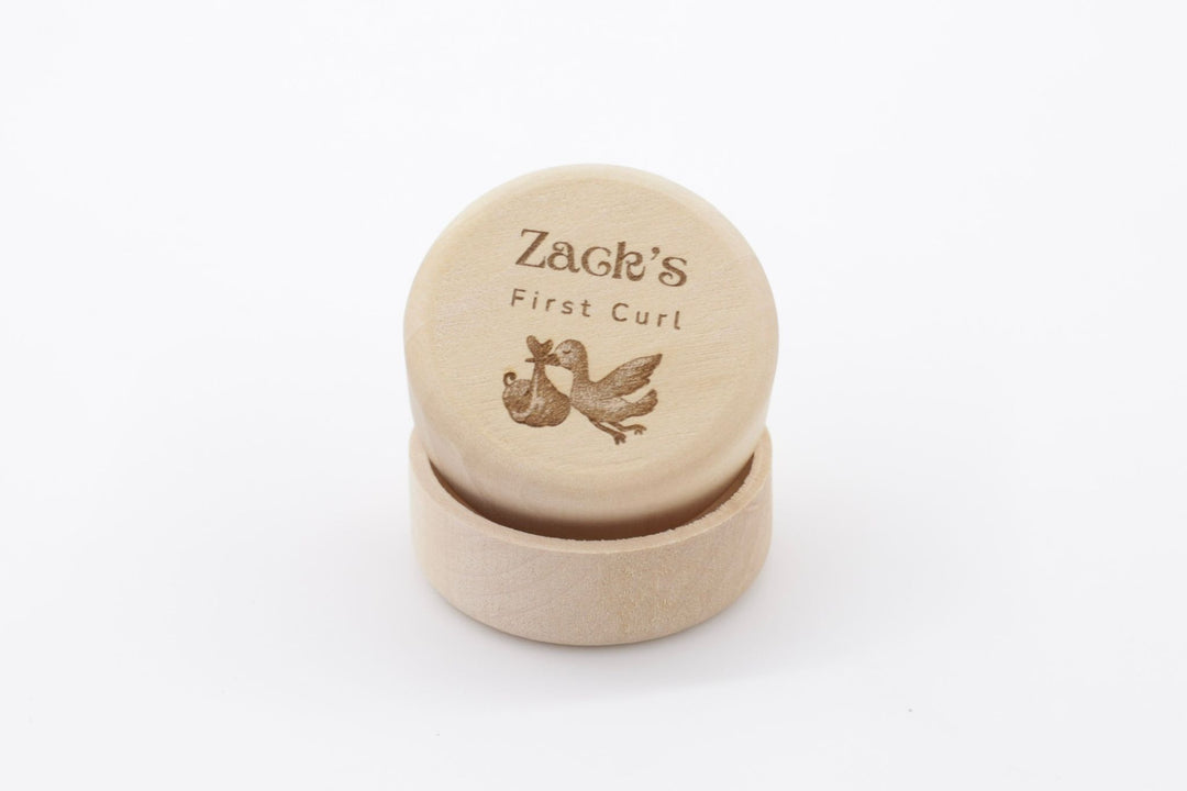 Mini wooden first curl box with name and an image of a stork carrying a baby engraved 