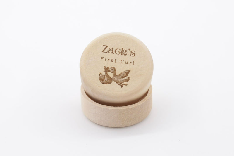 Mini wooden first curl box with name and an image of a stork carrying a baby engraved 