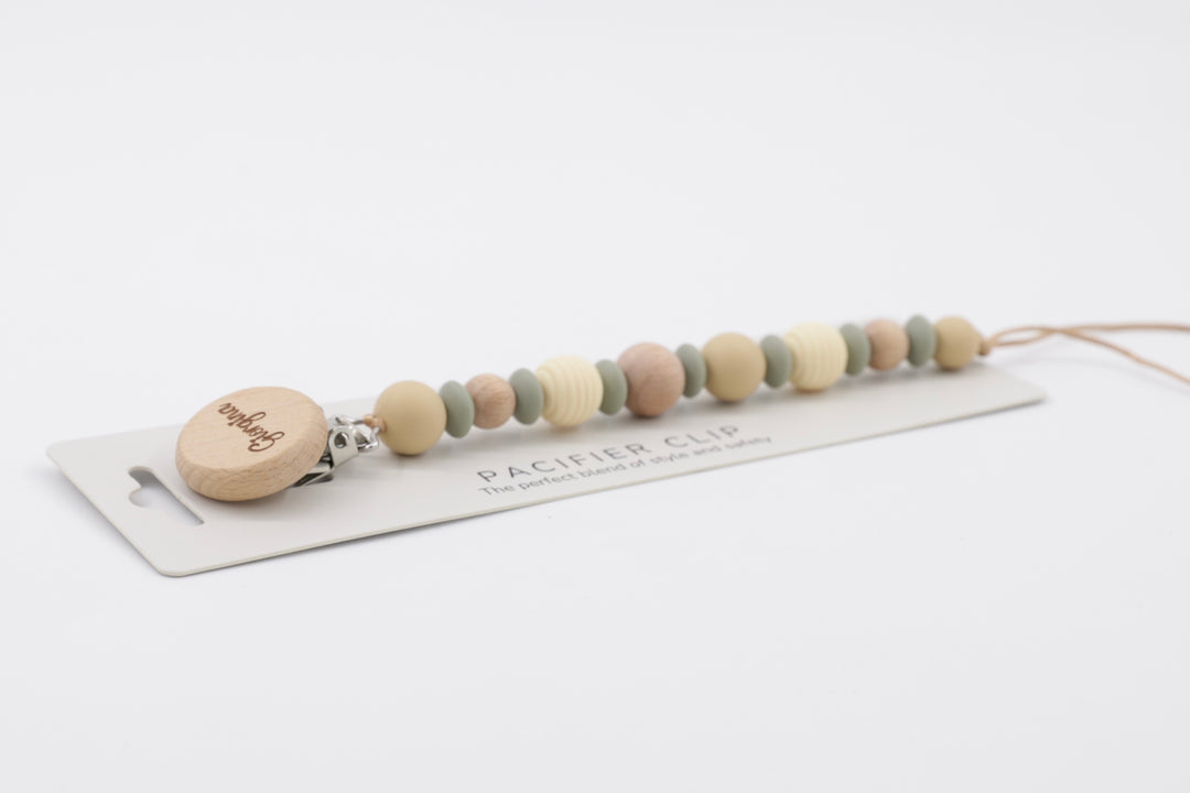 BabyStuff's Sage, Dune, and Birch Pacifier Clip on a white background