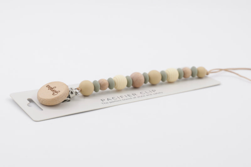 BabyStuff's Sage, Dune, and Birch Pacifier Clip on a white background