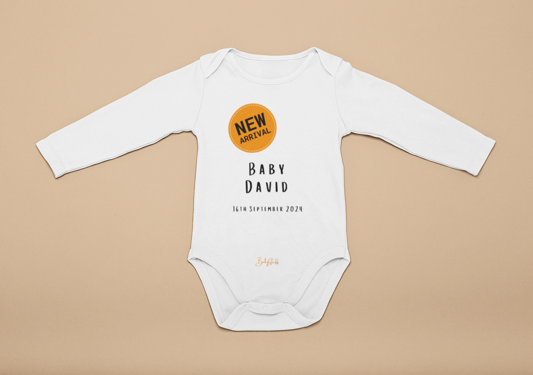 “New Arrival” Orange Badge Baby Grow | Long Sleeve Baby Grows by  – ["Baby Grow","Birthdate Celebration","New Arrival","Personalised"] from BabyStuff.com.mt