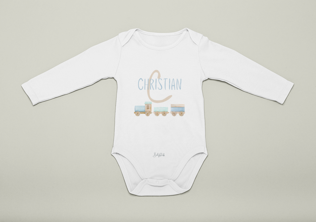 White baby onesie with blue 'Christian' printed on it against a beige background