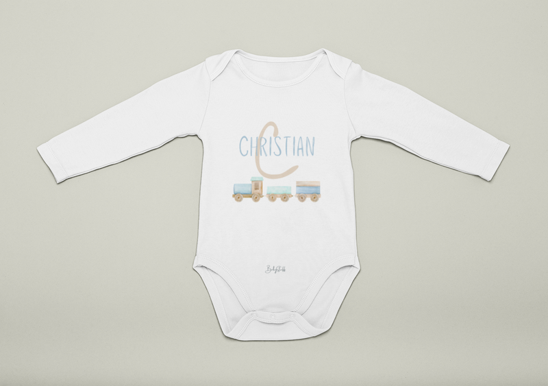 White baby onesie with blue 'Christian' printed on it against a beige background