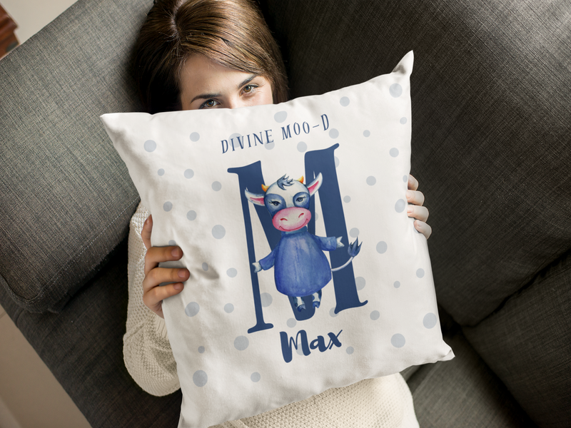 Mosaic Cow Cushion design with slogan "Divine Moo'd" being held by a girl